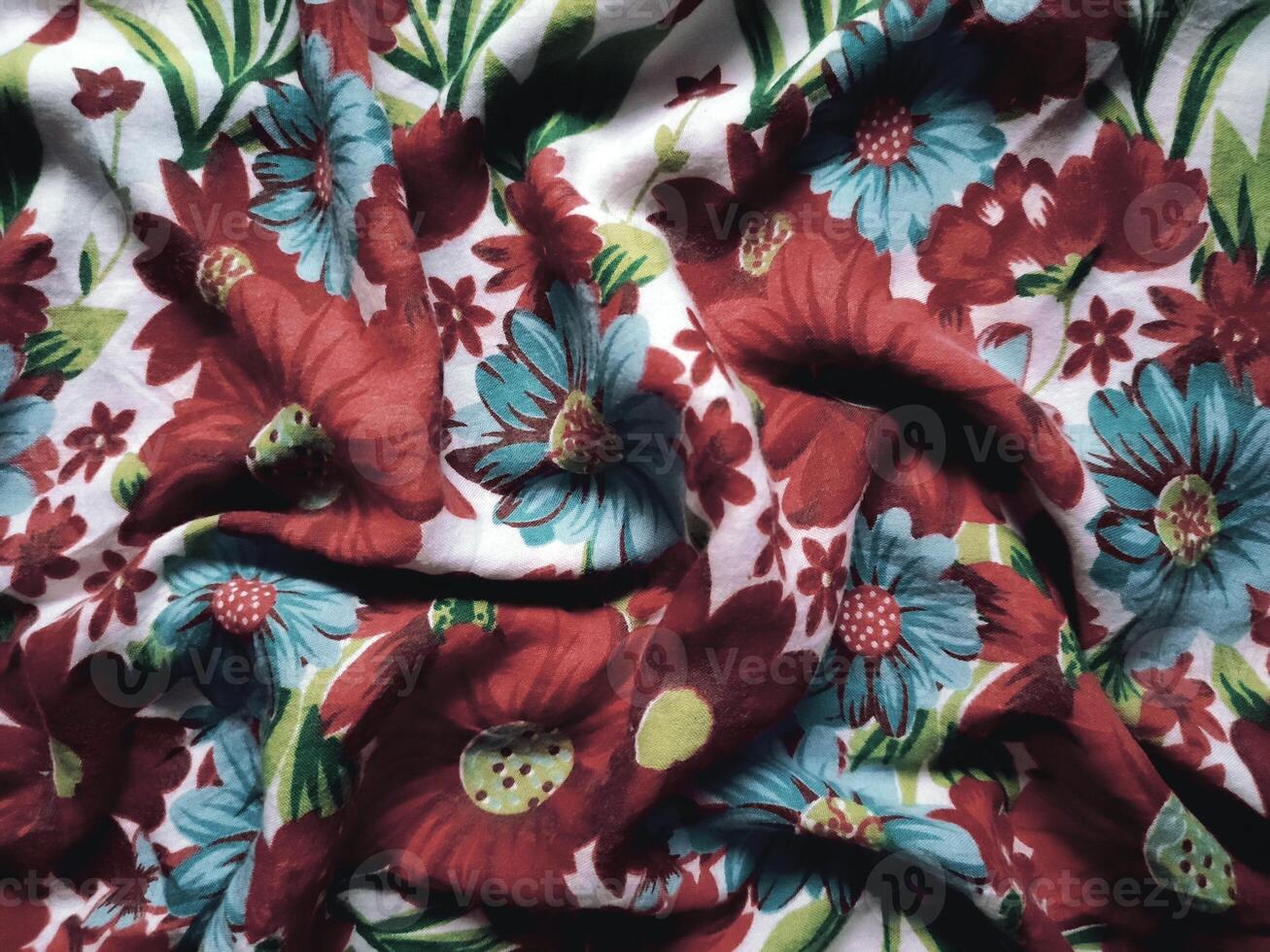 The basic fabric is white with red and blue floral motifs and leaves photo