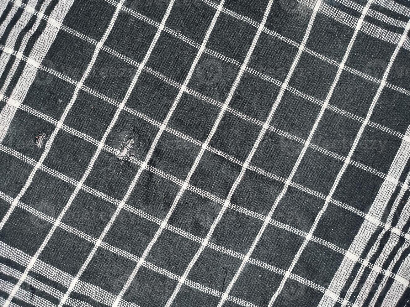 black rag with white lines isolated on white background. photo