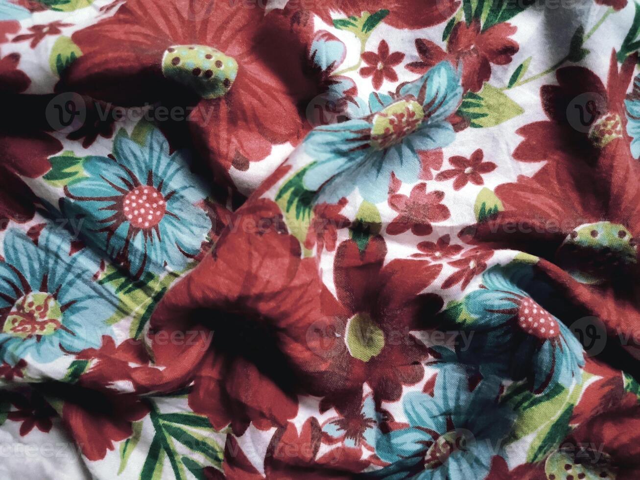 The basic fabric is white with red and blue floral motifs and leaves photo