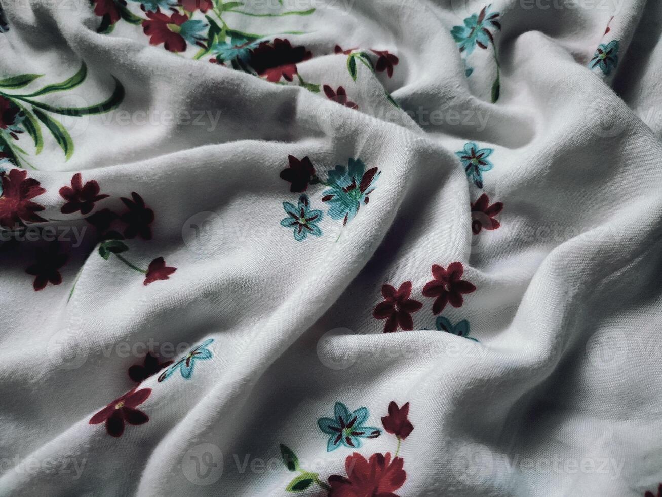 The basic fabric is white with red and blue floral motifs and leaves photo