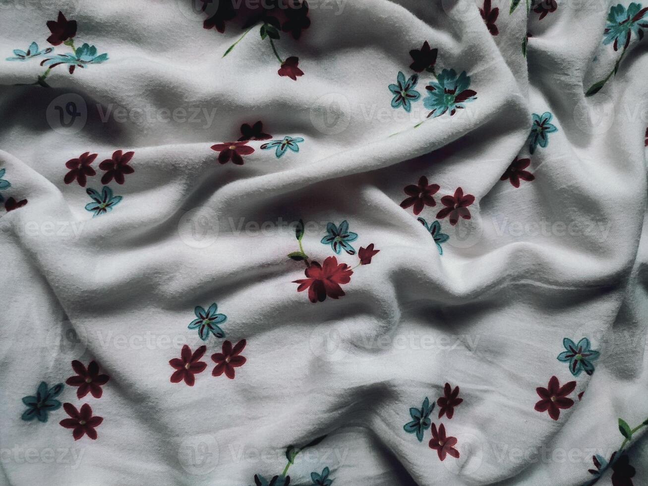 The basic fabric is white with red and blue floral motifs and leaves photo