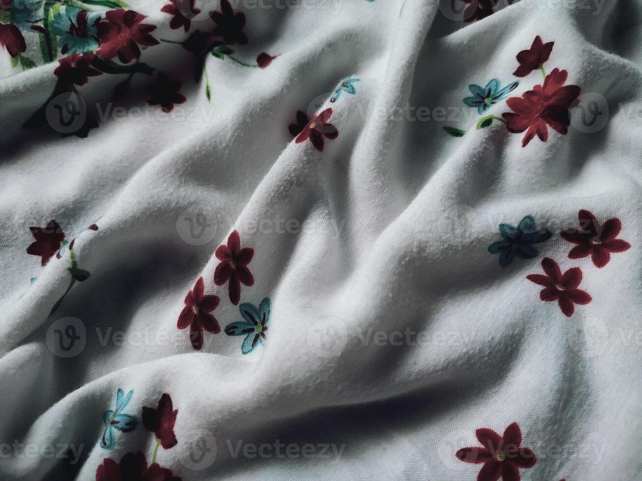 The basic fabric is white with red and blue floral motifs and leaves photo