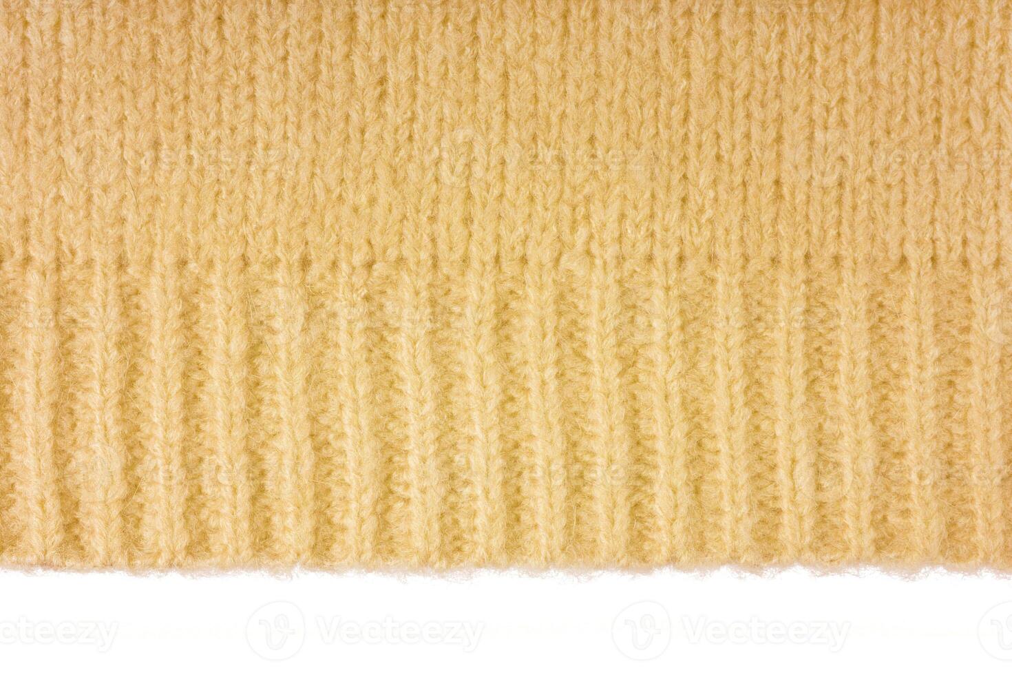 Yellow knitted woolen jersey fabric, sweater texture with edge isolated on white background photo