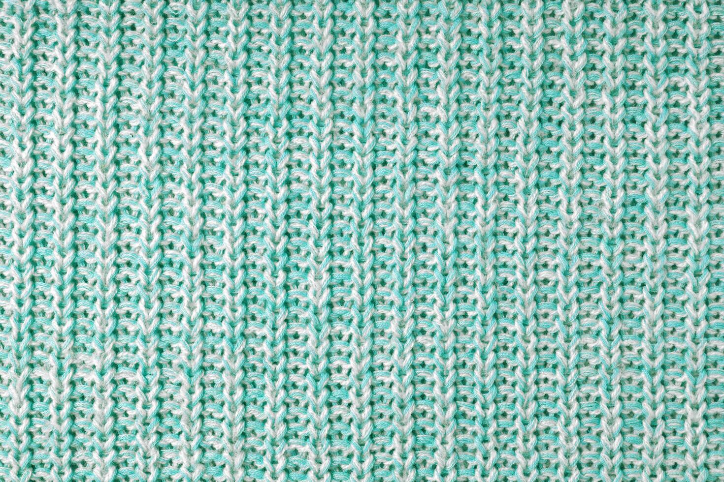 Jersey textile background , turquoise white melange knitted fabric, cloth surface photo