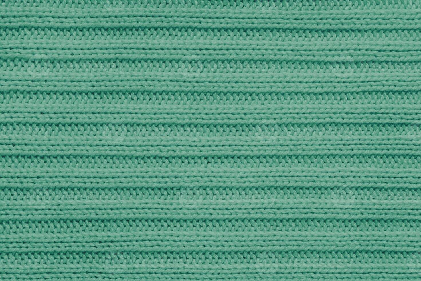 Jersey textile background , green striped knitted fabric, cloth surface photo