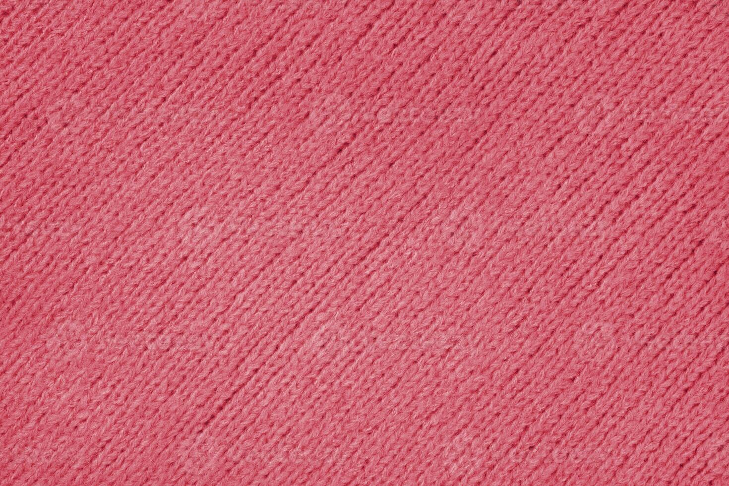 Red knitted woolen jersey fabric with diagonal weaving, sweater, pullover texture background photo