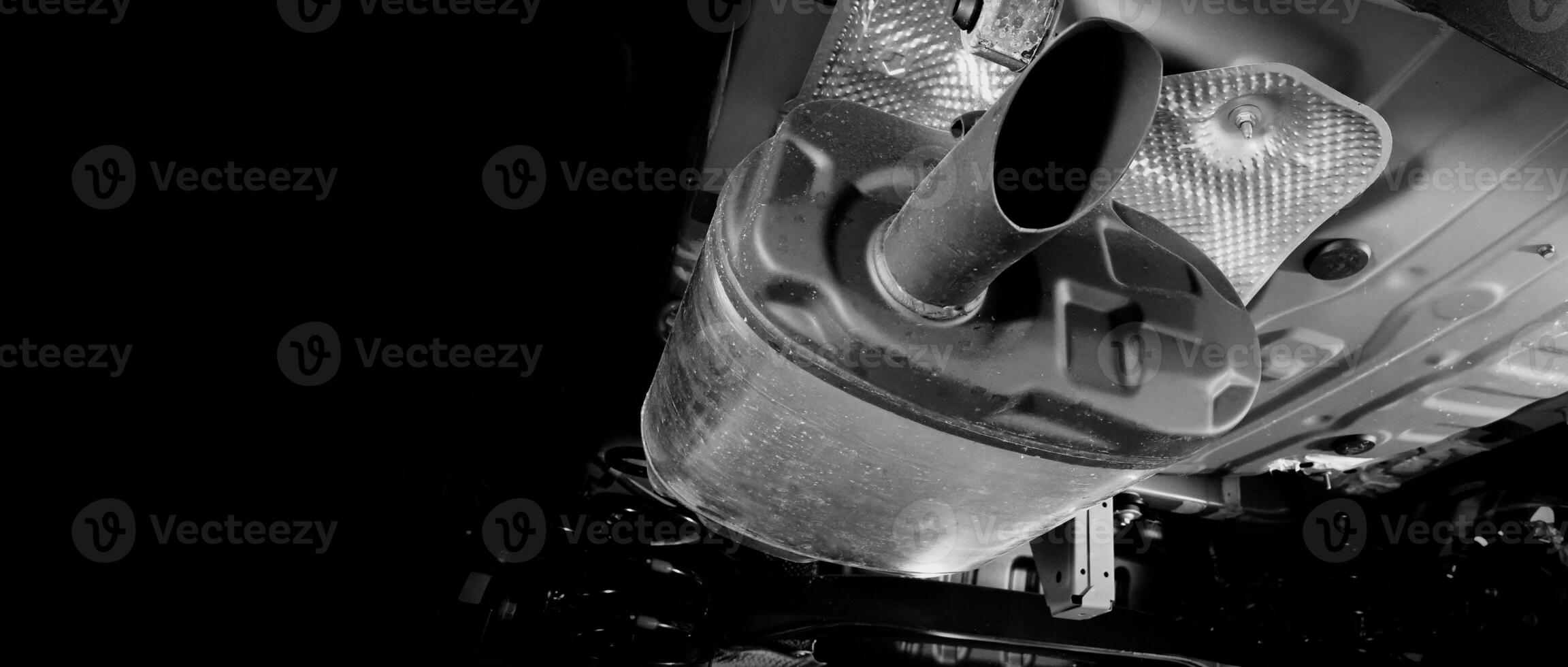 Under car exhaust pipe and suspension. Automotive mufflers. Inspection of car for Defects. Metal fittings and pipes for the muffler. Suspension elements and exhaust system. Auto parts and car service photo