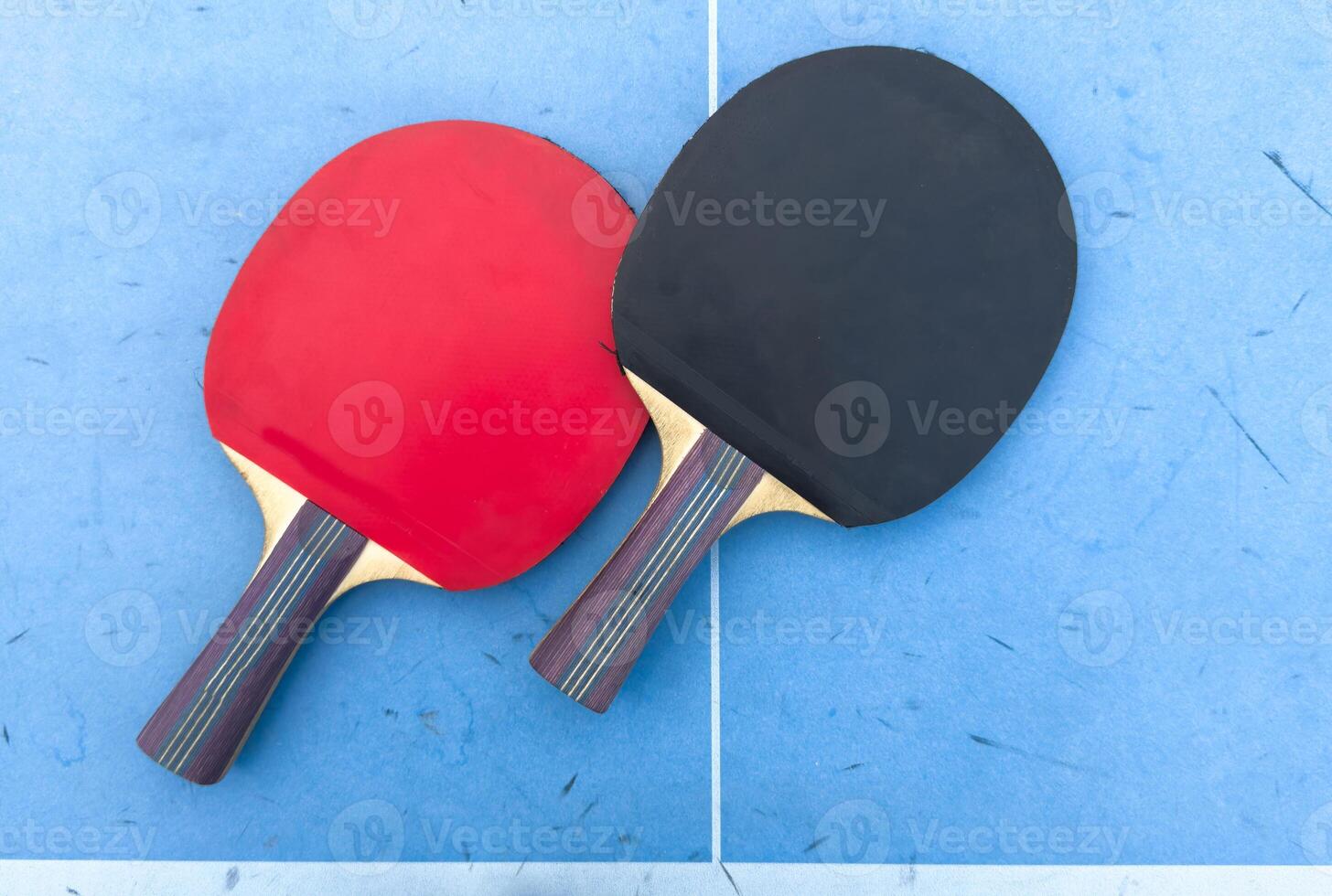 tennis rackets for playing ping pong on blue table, ping pong concept photo