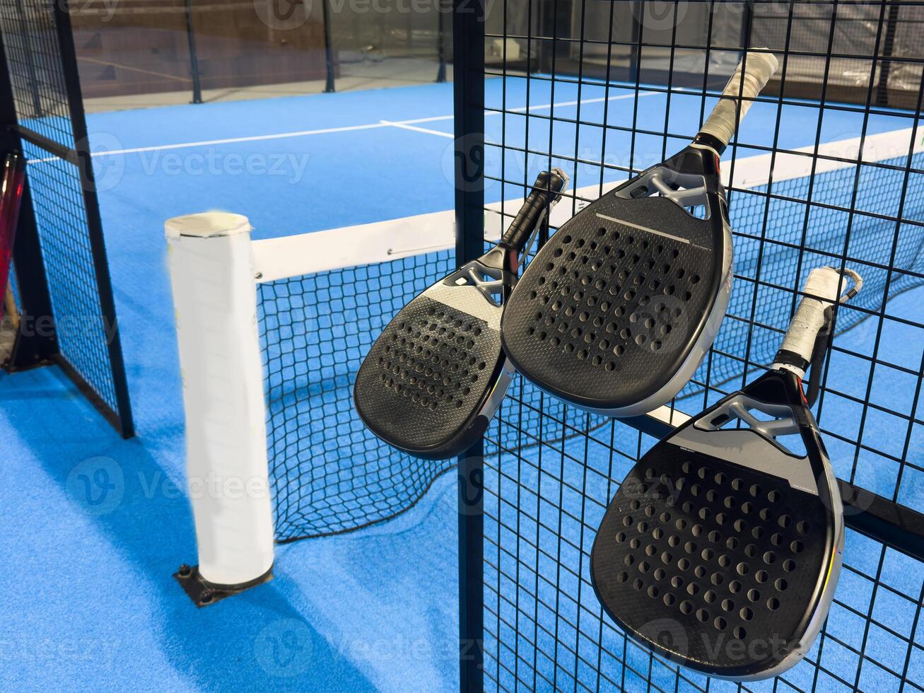 padel racket on a padel blue court with a ball photo