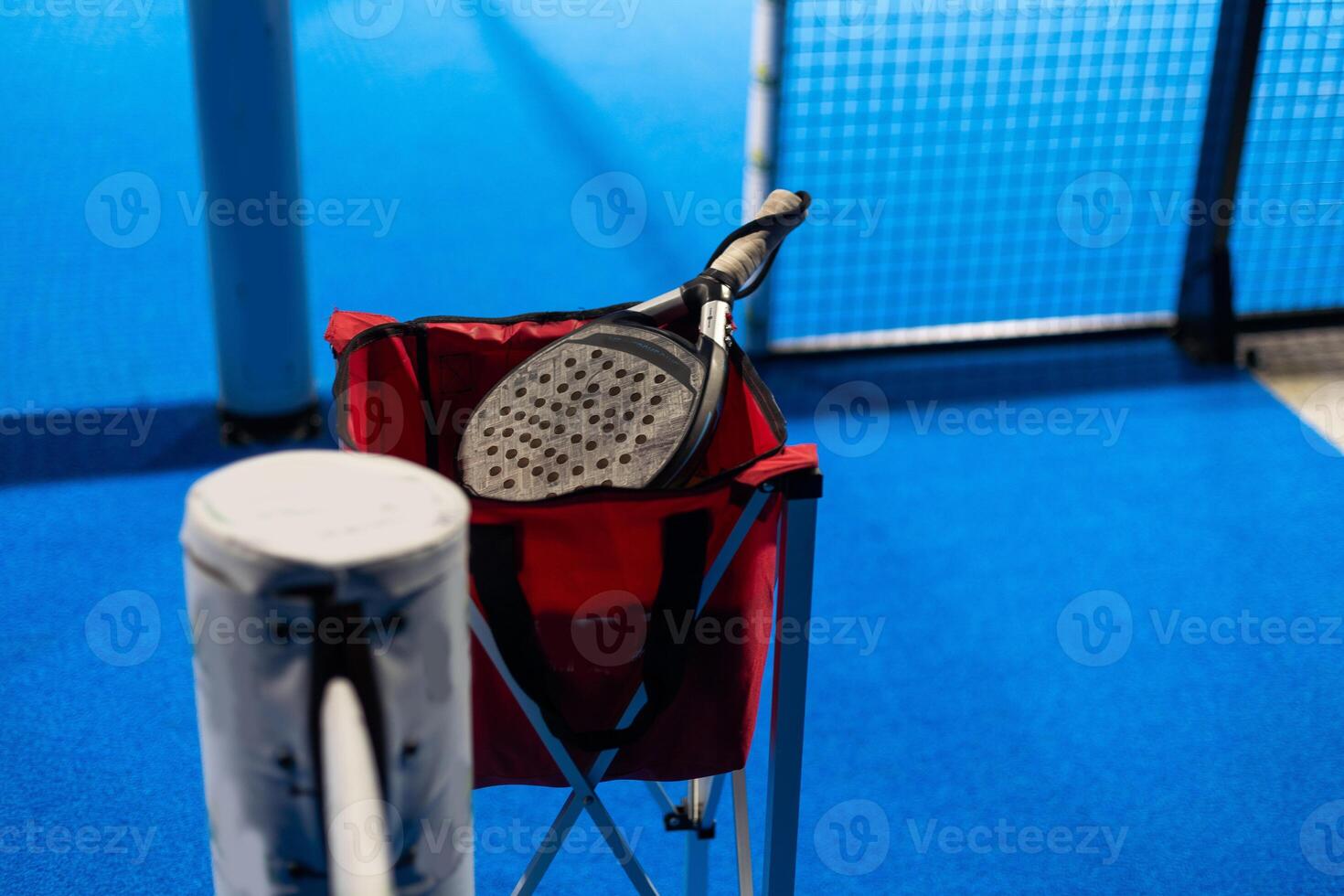 Paddle ball on racket. Yellow paddle ball laying near racket, photo