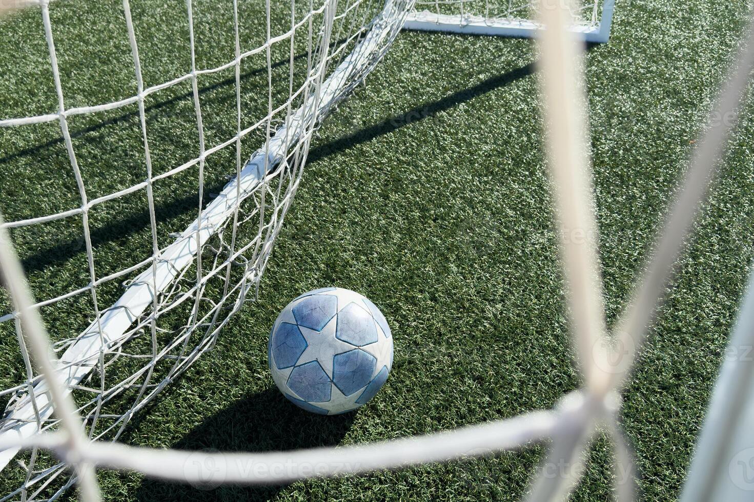 Soccer ball on a grass football field photo