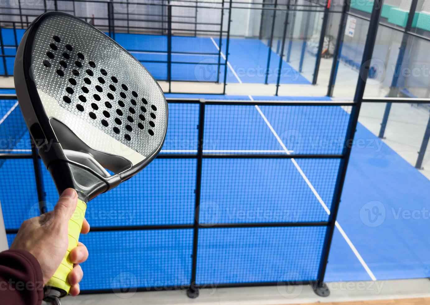 padel racket on a padel court with a ball photo