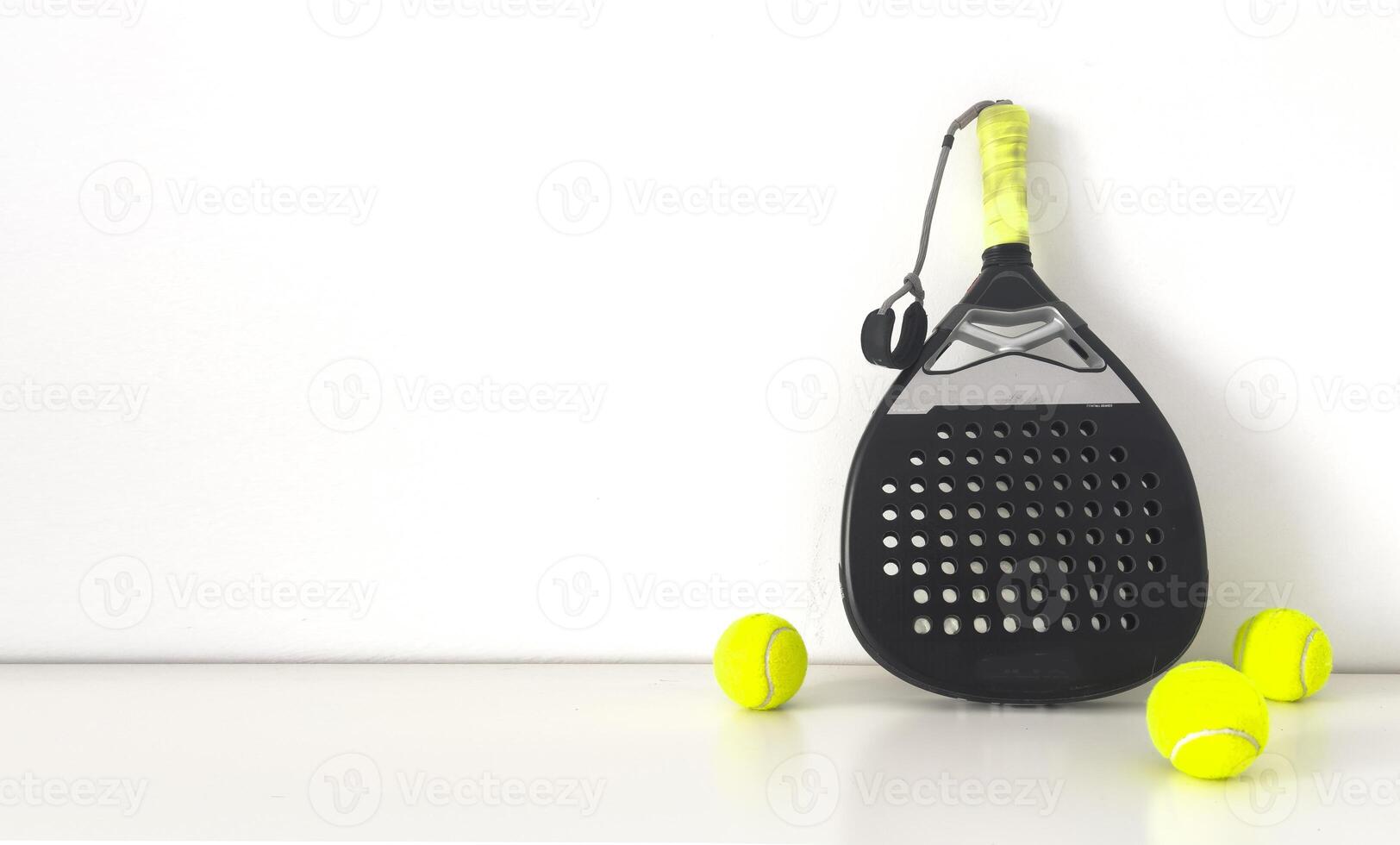 Background of black and white paddle tennis racket and balls photo