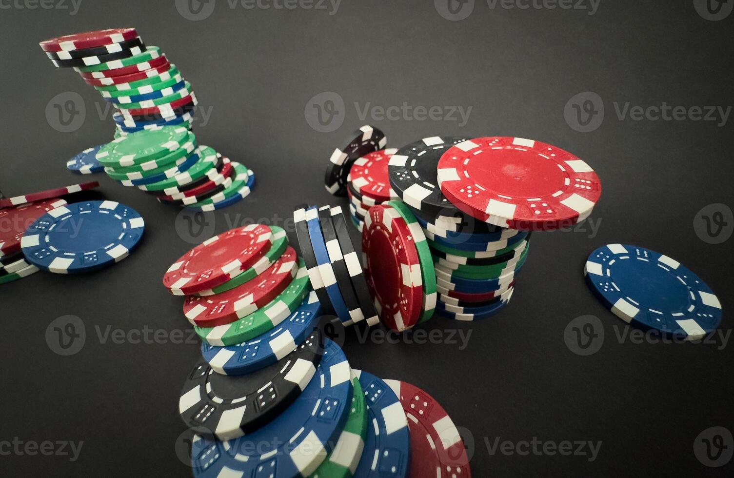 Colorful different value poker chips on black casino table, win after game. Concept of hazard gaming photo