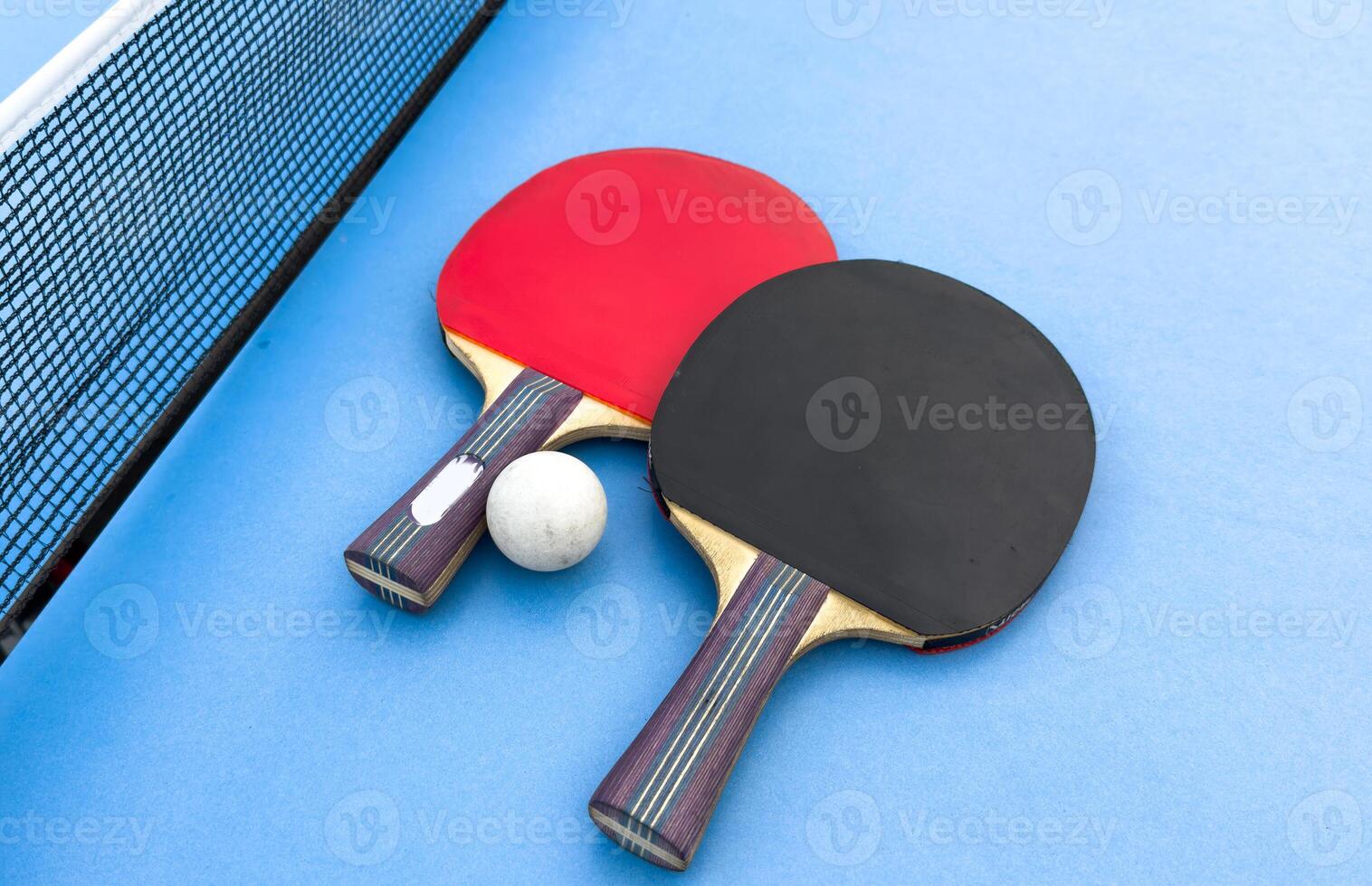 tennis rackets for playing ping pong on blue table, ping pong concept, active sports photo