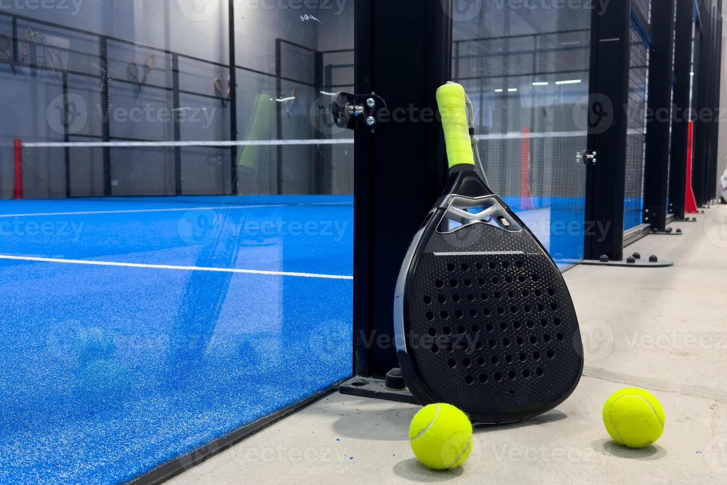 padel racket on a padel court with a ball photo