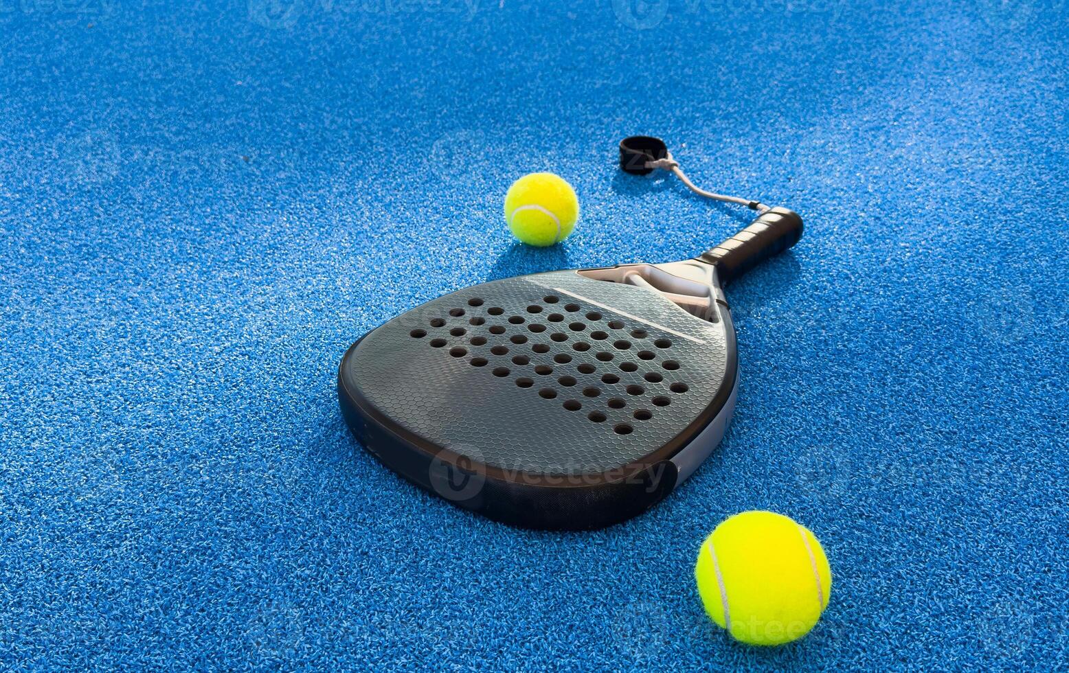 Padel tennis racket. Background with copy space. Sport court and balls. photo