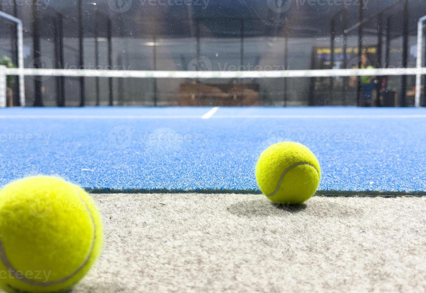 Blue paddle court, with balls. With view of the net and the lines photo