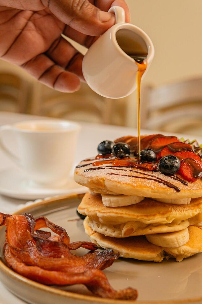 Fruit crepes with chocolate and maple syrup for breakfast photo