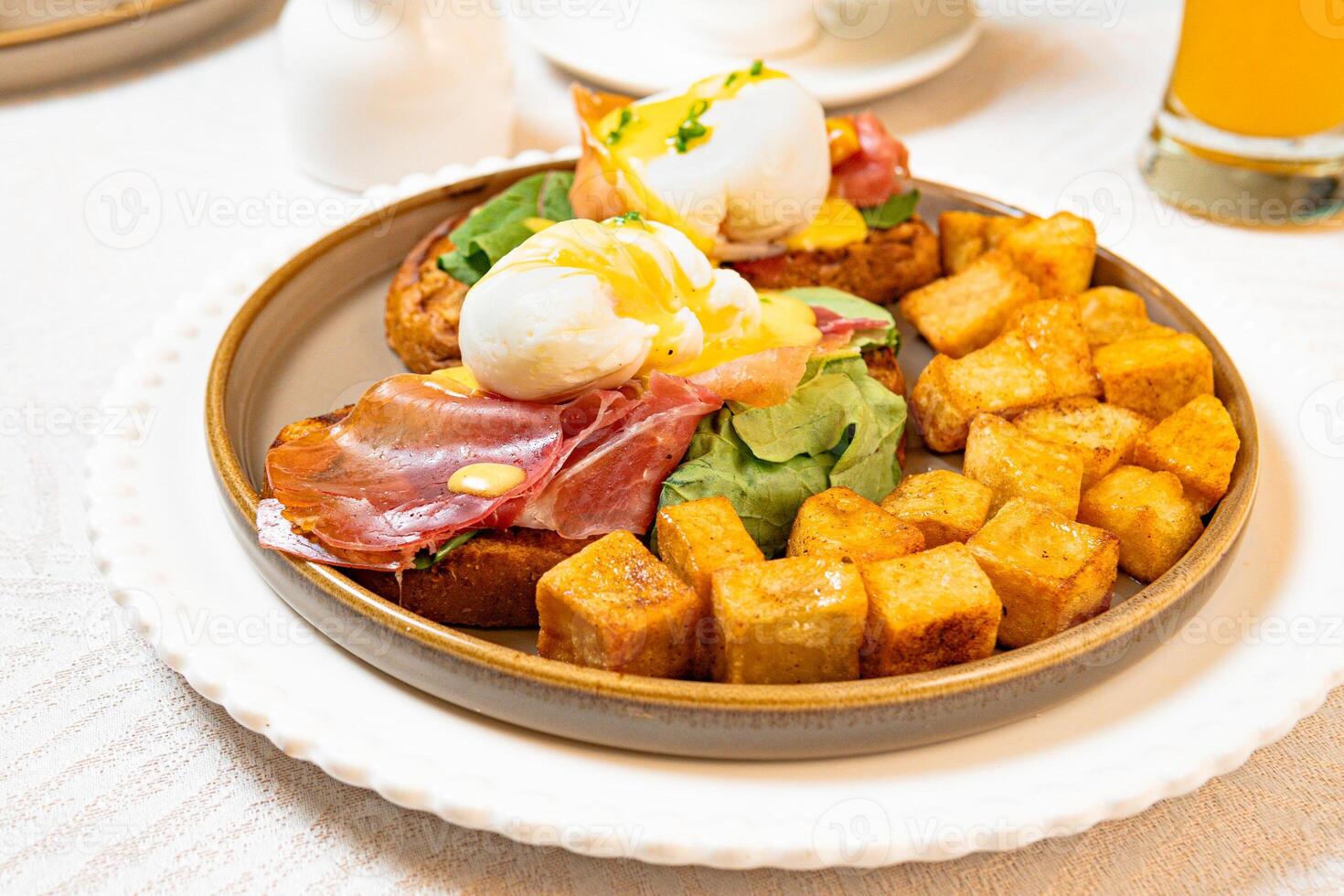 Gourmet breakfast with pieces of pork cracklings, toast, burrata, and serrano ham photo