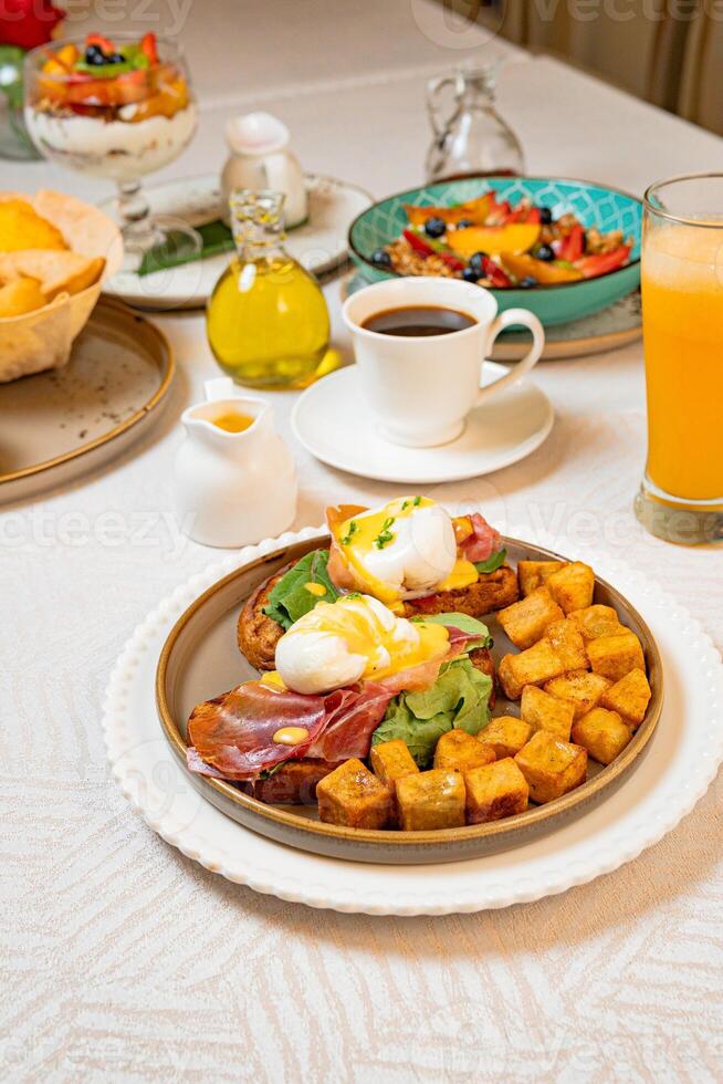 Gourmet breakfast with pieces of pork cracklings, toast, burrata, and serrano ham photo