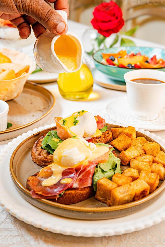 Gourmet breakfast with pieces of pork cracklings, toast, burrata, and serrano ham photo