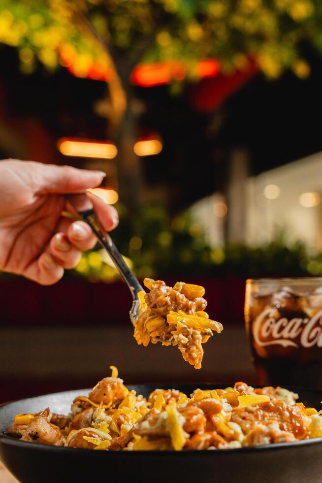 Colombian-style desgranado, featuring corn, chicken, beef, vegetables, shredded potato, French fries, and a variety of sauces. photo