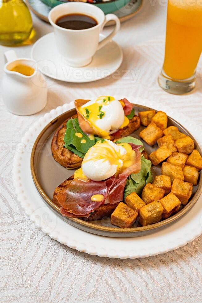 Gourmet breakfast with pieces of pork cracklings, toast, burrata, and serrano ham photo