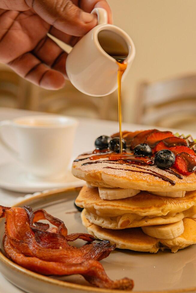 Fruit crepes with chocolate and maple syrup for breakfast photo