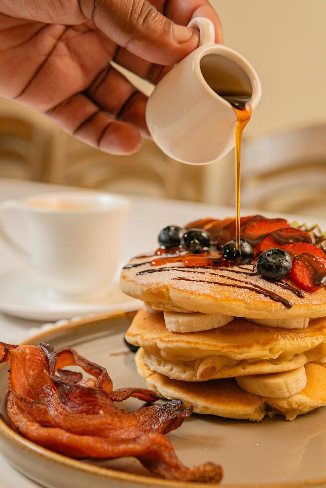 Fruit crepes with chocolate and maple syrup for breakfast photo