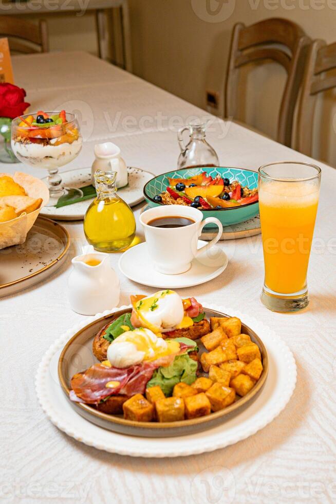 Gourmet breakfast with pieces of pork cracklings, toast, burrata, and serrano ham photo