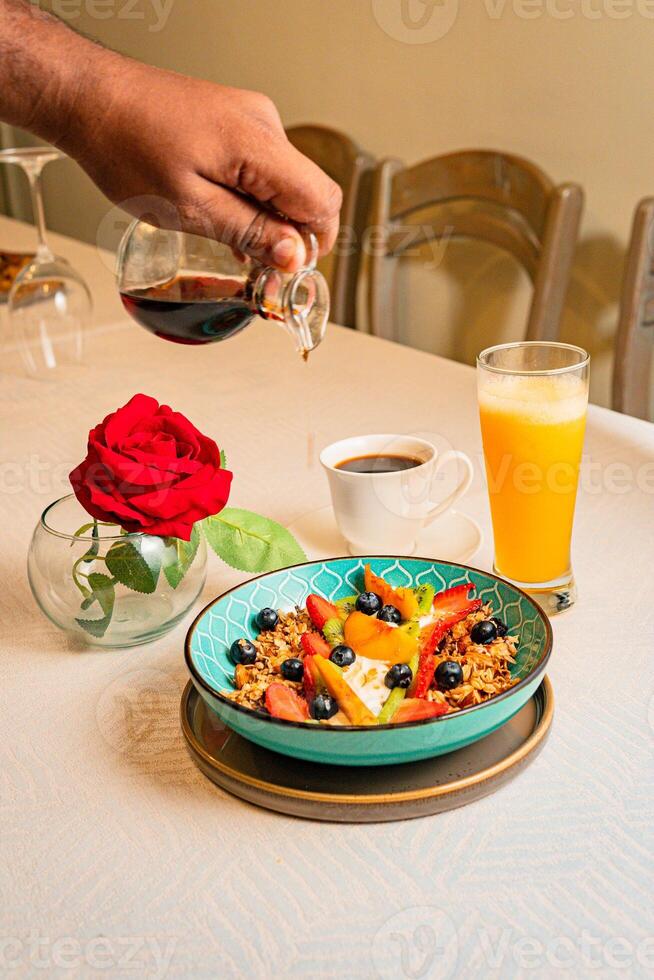 Breakfast with a big bowl of fruit, coffee, and orange juice photo