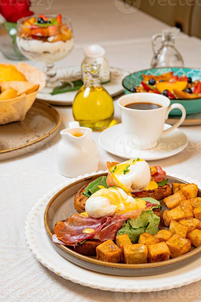 Gourmet breakfast with pieces of pork cracklings, toast, burrata, and serrano ham photo