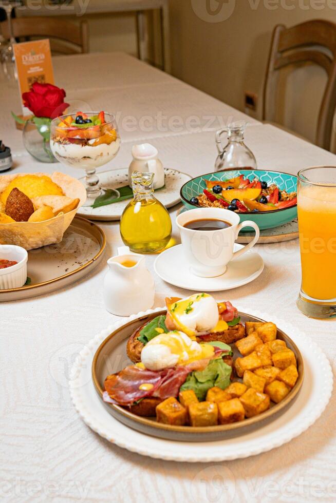 Gourmet breakfast with pieces of pork cracklings, toast, burrata, and serrano ham photo