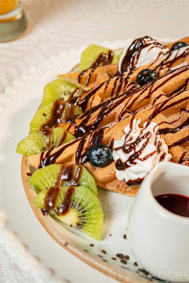 Fruit crepes with chocolate and maple syrup for breakfast photo