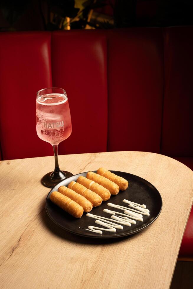 Cheese sticks with buttermilk on a black plate. photo