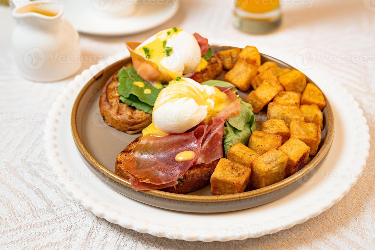 Gourmet breakfast with pieces of pork cracklings, toast, burrata, and serrano ham photo
