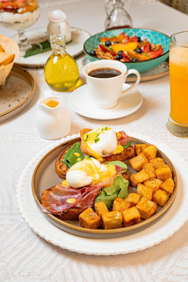 Gourmet breakfast with pieces of pork cracklings, toast, burrata, and serrano ham photo