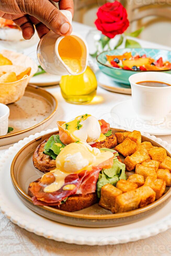 Gourmet breakfast with pieces of pork cracklings, toast, burrata, and serrano ham photo