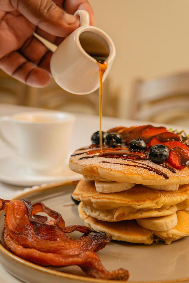 Fruit crepes with chocolate and maple syrup for breakfast photo