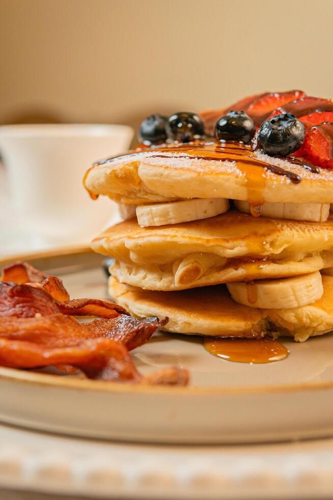 Fruit crepes with chocolate and maple syrup for breakfast photo