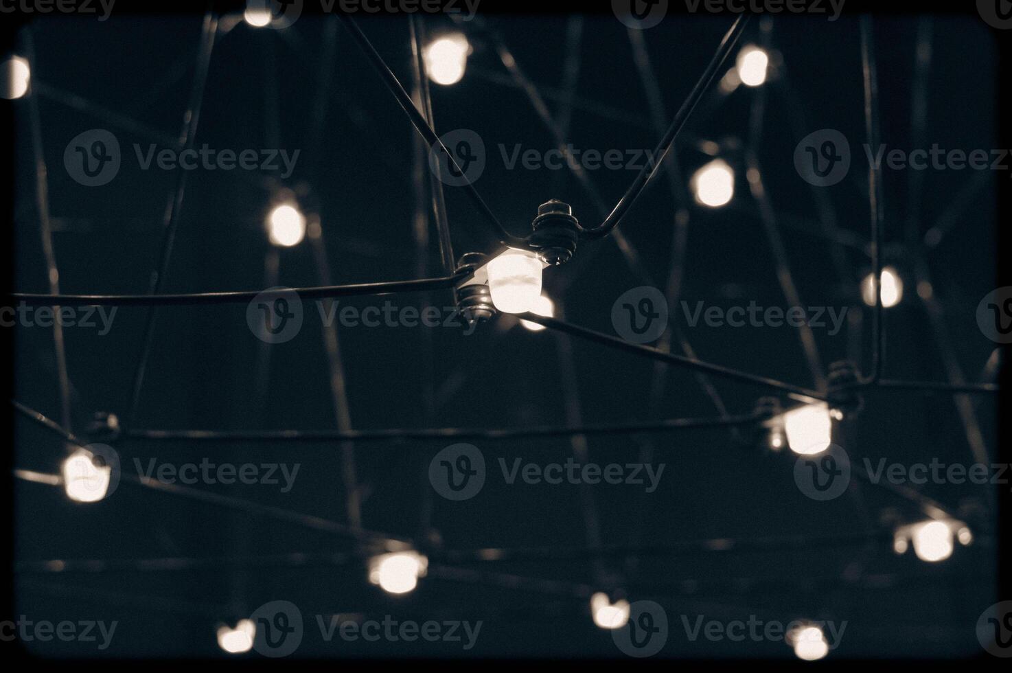 abstract background is a metal structure made of thin rods with light bulbs in a geometric sequence. strange art objects for home and office. High quality photo