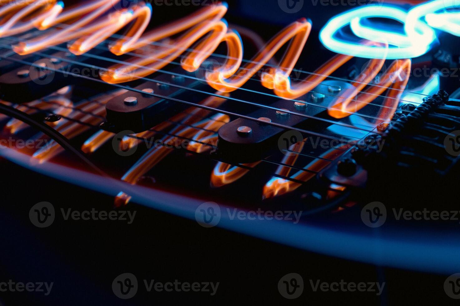 Abstract photo of an electric guitar and its parts macro photo. Music wallpaper and banner for string music album. High quality photo guitar in dark with light reflected in the lacquered surface.