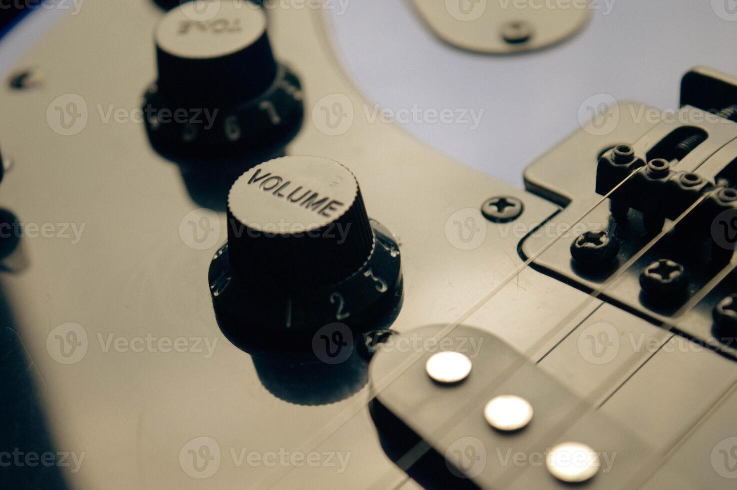 Abstract photo of an electric guitar and its parts macro photo. Music wallpaper and banner for string music album. High quality photo guitar in dark with light reflected in the lacquered surface.