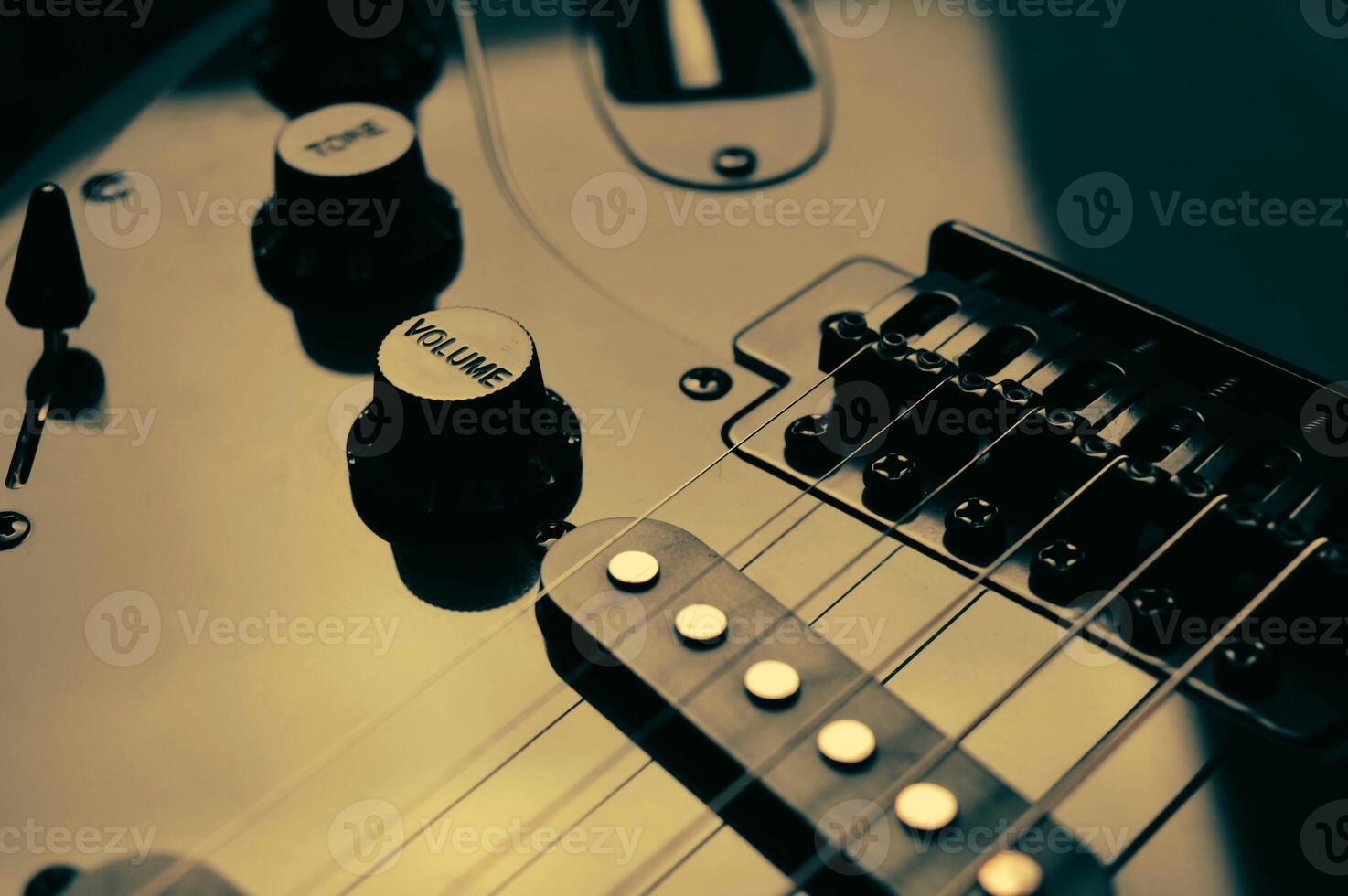 Abstract photo of an electric guitar and its parts macro photo. Music wallpaper and banner for string music album. High quality photo guitar in dark with light reflected in the lacquered surface.