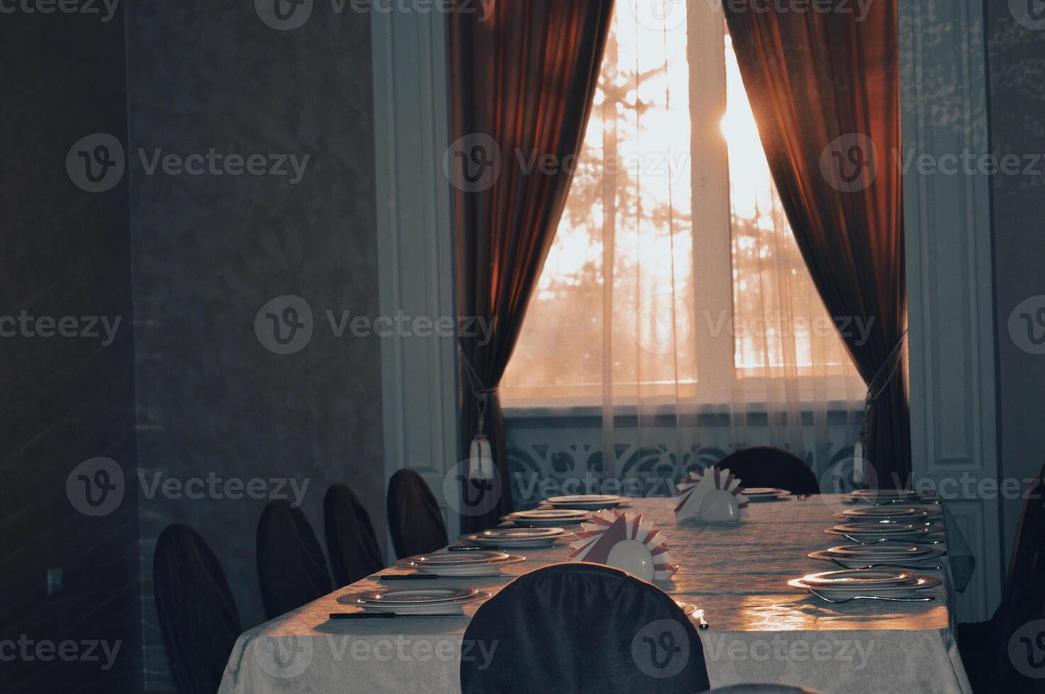 an empty hall is a classic restaurant with curtains white tablecloths and Romanesque decor. High quality photo