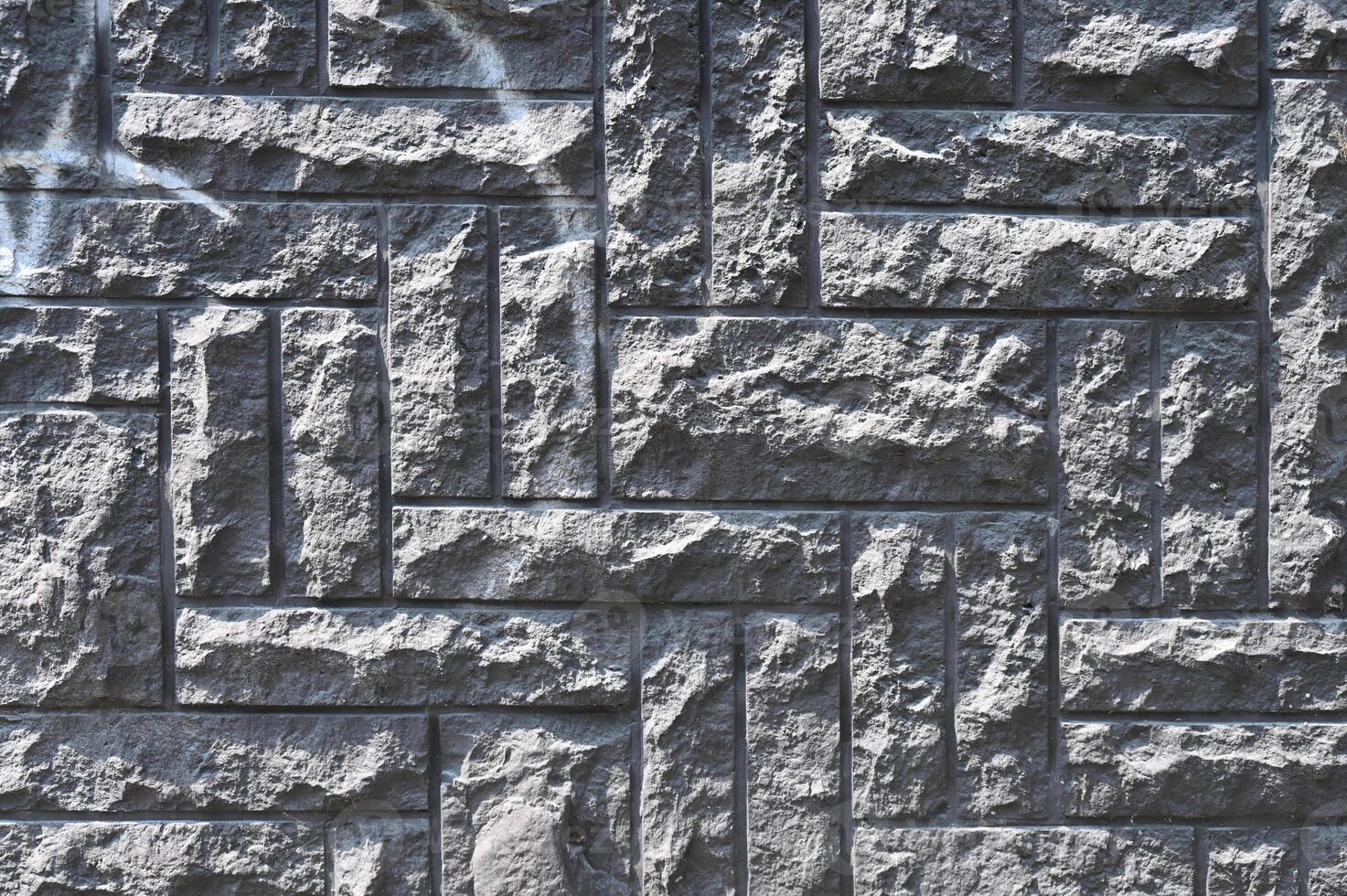 a wall made of stone with a pattern of squares photo