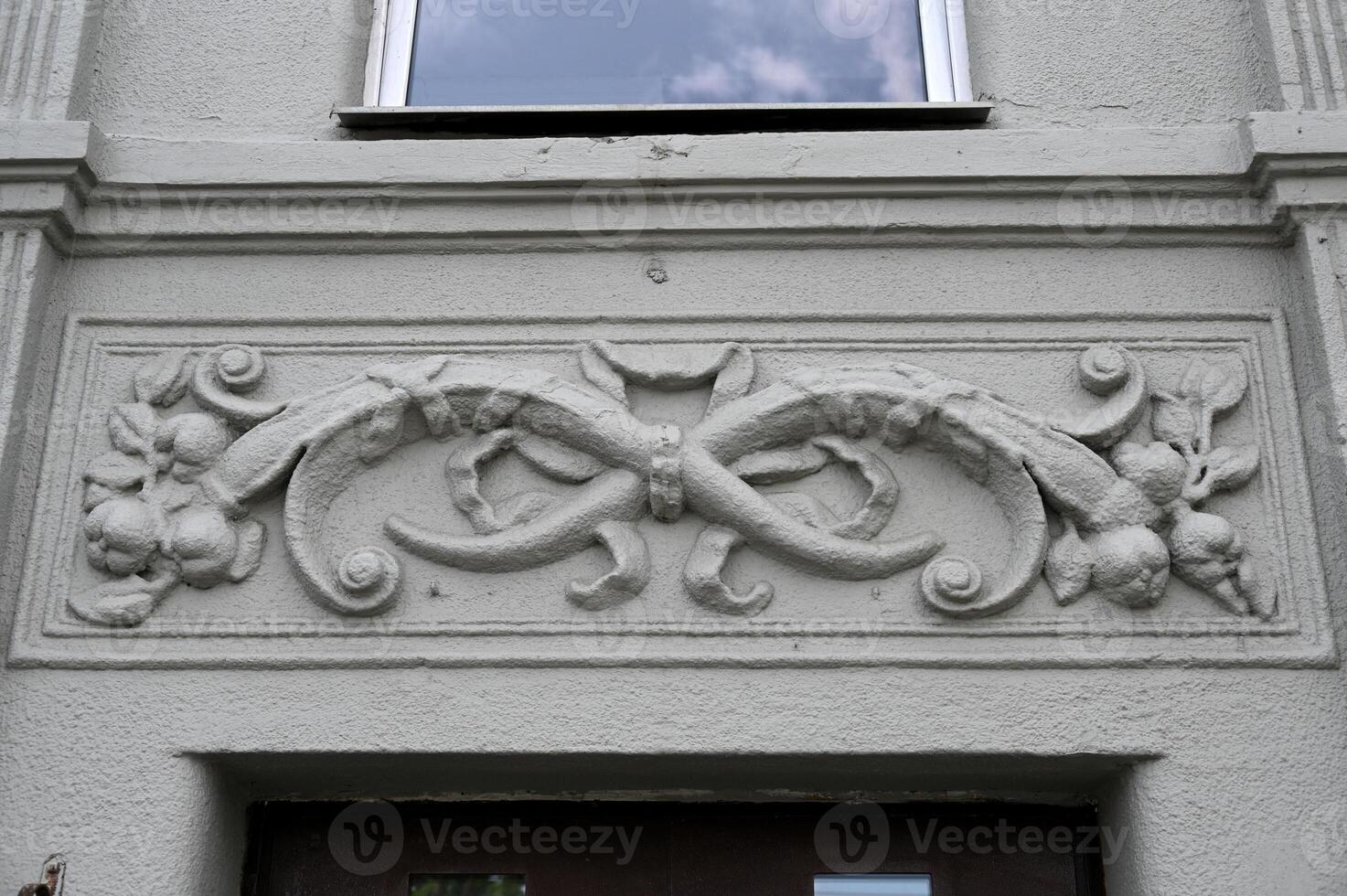 a decorative carving on the side of a building photo