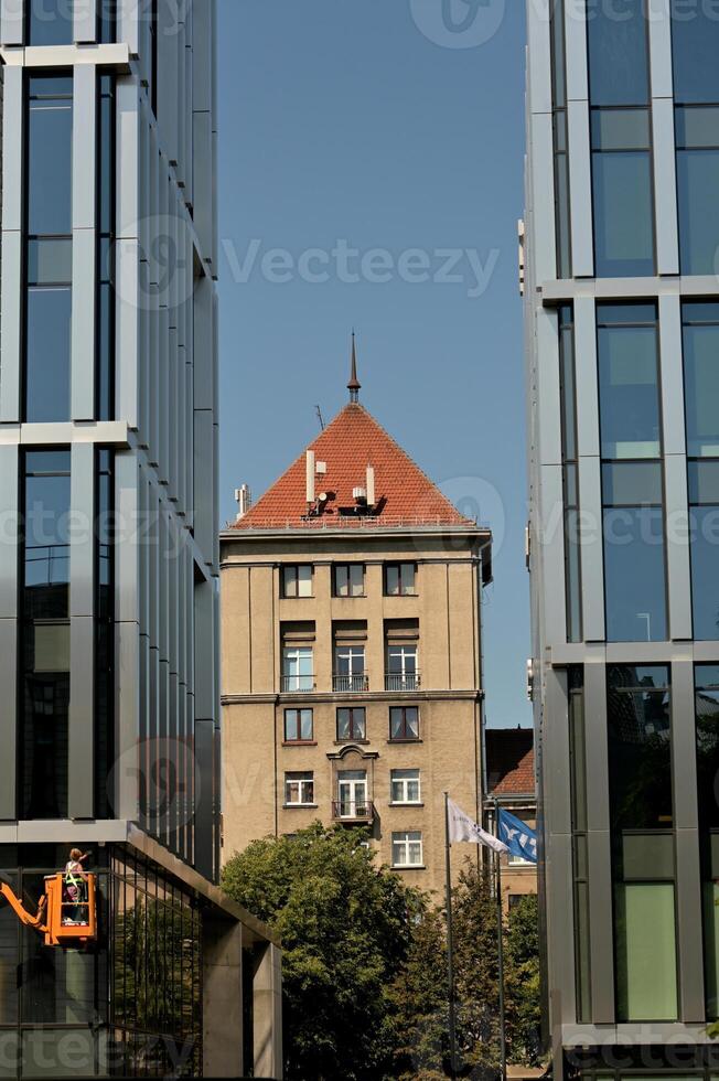a man is standing on a ladder in front of a building photo