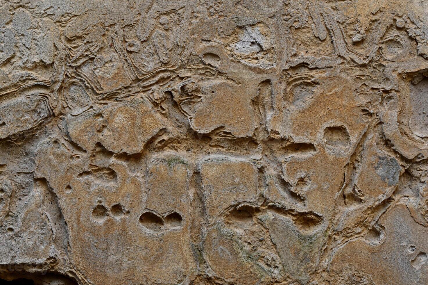 a large rock wall with many different shapes and designs photo